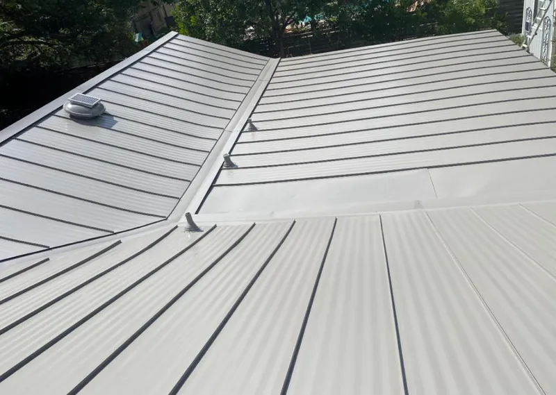 Solar attic fan installed on a metal roof for Roof Ventilation in Niagara Falls